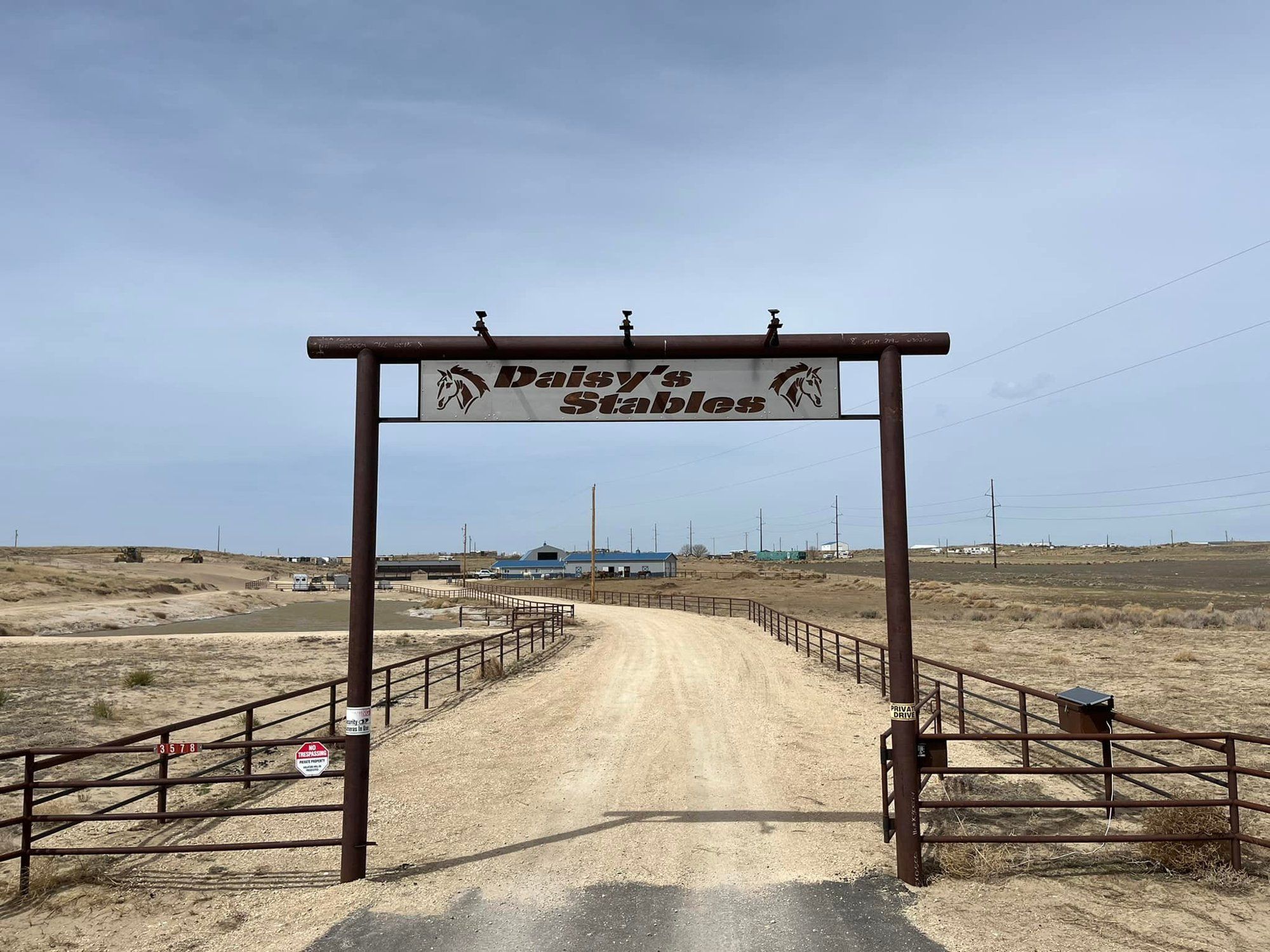 Daisy's Stables entrance gate on the ranch road